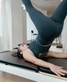 Alumna de ELIX Pilates en colchoneta elevando piernas durante la clase